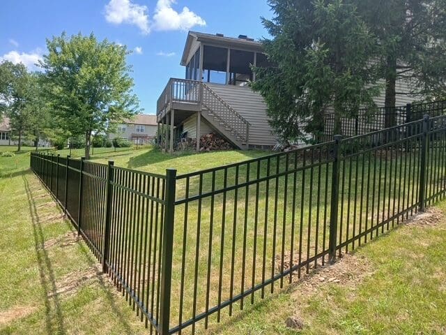 Black metal fence around a grassy yard.